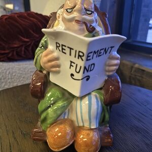 Colorful Ceramic Figurine with Retirement Fund Book